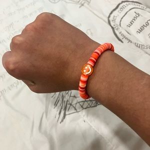 Hi this is a orange cley bead bracelet